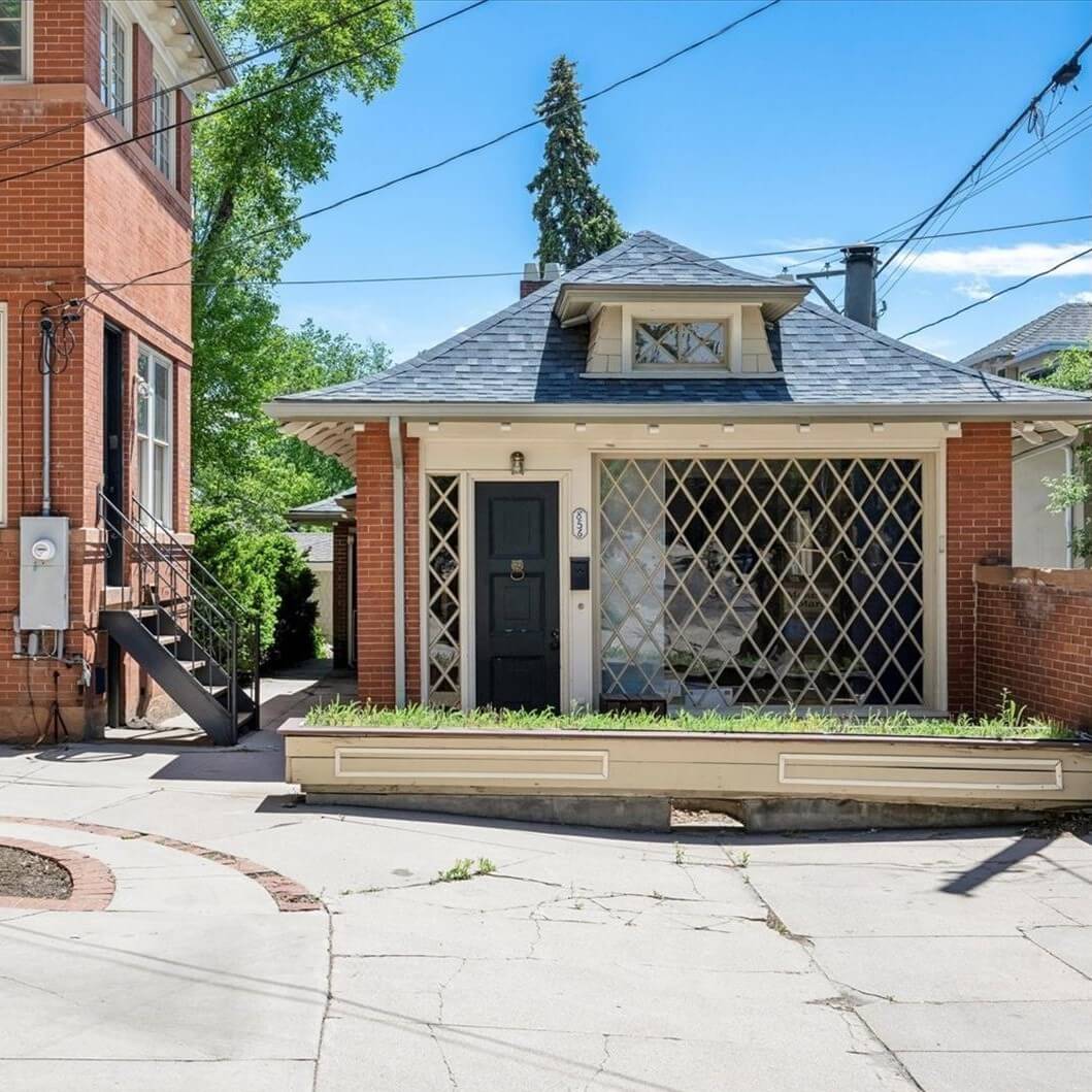 Detached accessory dwelling unit behind a larger home.