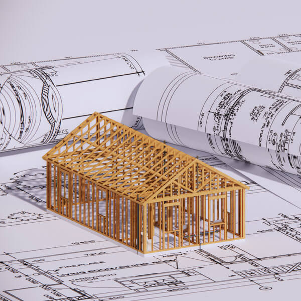 Framed home model sitting on blue prints.